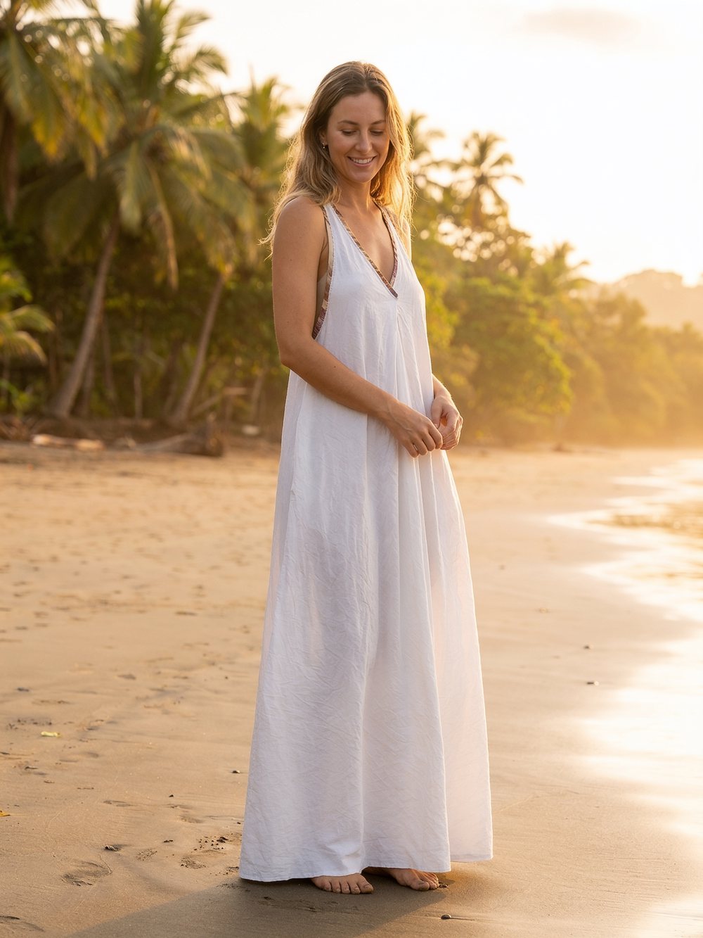 White V-neck maxi dress on the beach at golden hour